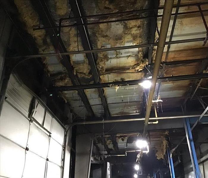 Burnt insulation in ceiling of manufacturing facility