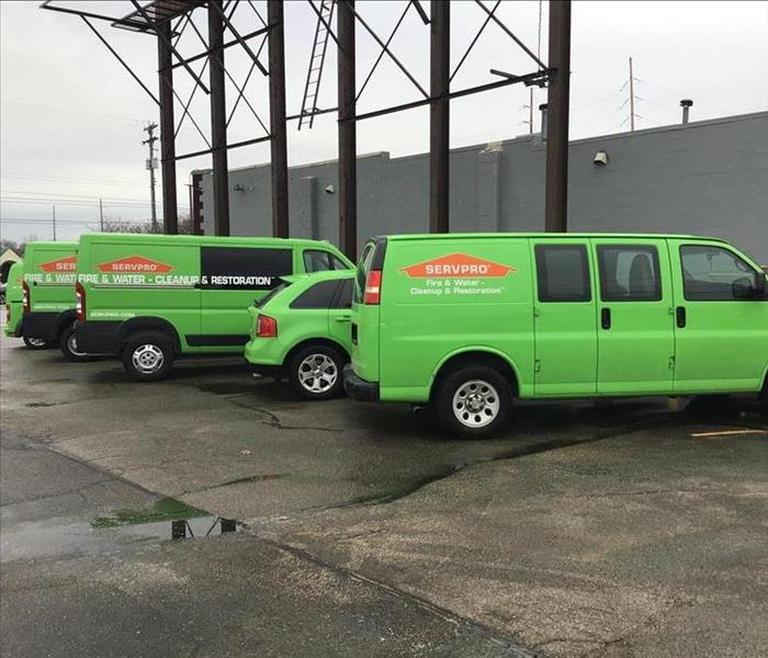 Multiple SERVPRO vehicles outside a commercial fire.