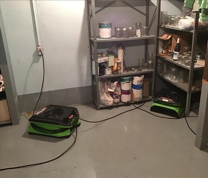 Clean laundry room floor in a residential basement after a sewer backup.